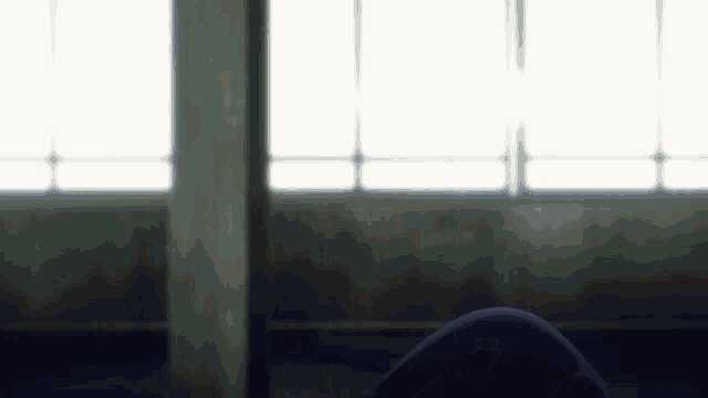 a person sitting in front of a large window