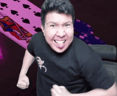 a man in a black shirt with a scorpion on it is making a funny face