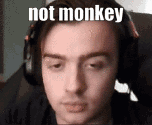 a man wearing headphones with the words `` not monkey '' on his face
