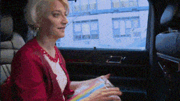 a woman in a red jacket is sitting in a car