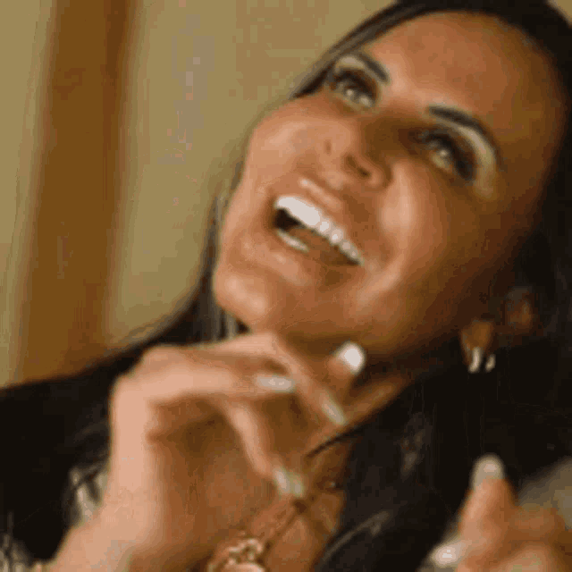 a woman is laughing with her mouth open
