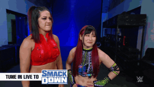 two women are standing next to each other with the words tune in live to smack down