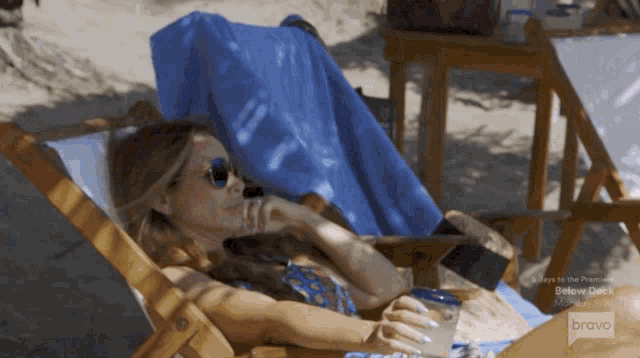 a woman in a bikini is laying in a chair with bravo written on the bottom of the screen
