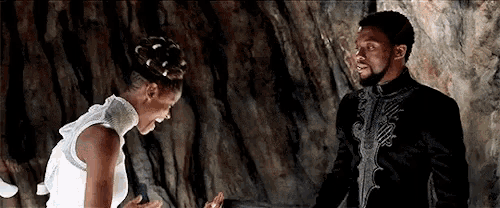 a man and a woman are standing next to each other and laughing .