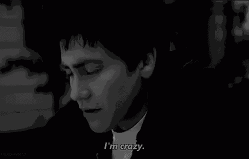 a black and white photo of a man 's face with the words `` i 'm crazy '' .