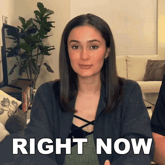 a woman says right now in front of a plant