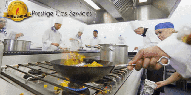 a group of chefs are preparing food in a kitchen with a prestige gas services logo