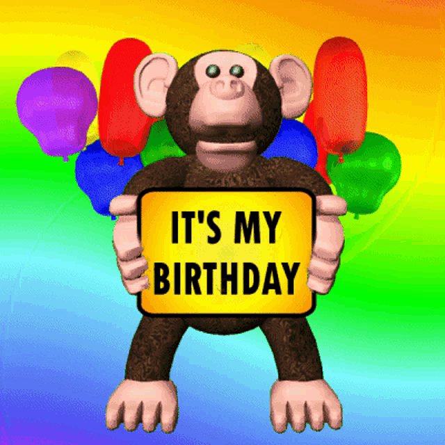 a stuffed monkey holding a sign that says it 's my birthday