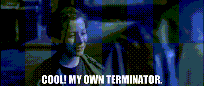 a woman is talking to a man in a dark room and the words cool my own terminator are visible .