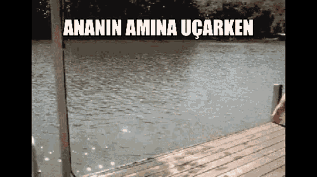 a person is jumping into a body of water with the words ananin amina ucarken
