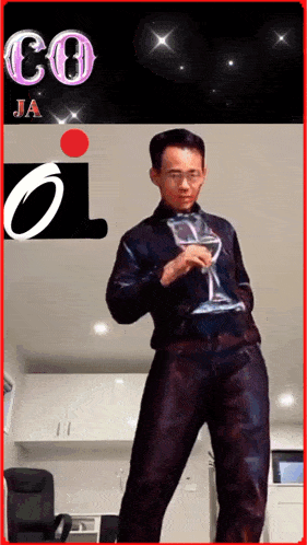 a man is holding a glass of wine in front of a ja logo