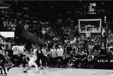 a black and white photo of a basketball game with a score of 3.6