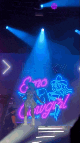 a neon sign on a stage that says lucky cowgirl