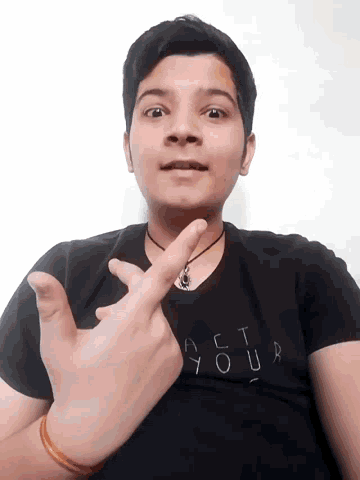 a young man wearing a black shirt that says " your " on it