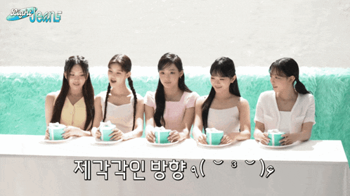 a group of girls sitting at a table with a sign that says ' smart jeans ' on it