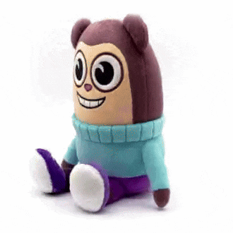 a stuffed animal that looks like a monkey wearing a blue sweater and purple pants .