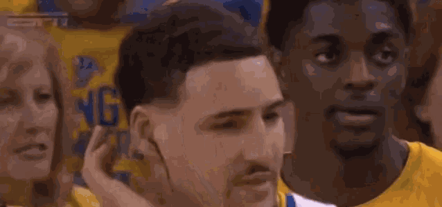 a basketball player is talking to his teammates during a game .