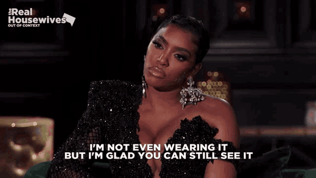 a woman wearing a black dress says i 'm not even wearing it