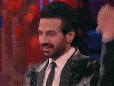 three men in tuxedos are standing next to each other