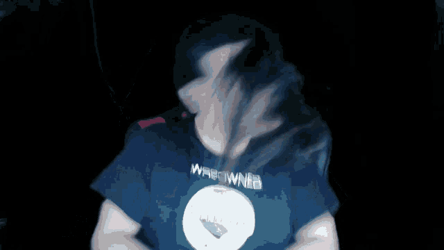 a blurry image of a man wearing a shirt that says weedweed