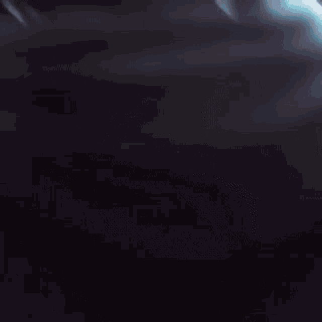 a close up of a person 's face with a blurry background and a blue light coming out of it .