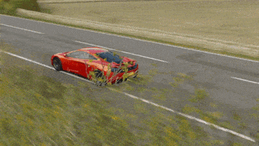 a red car is driving down a road with the hood open