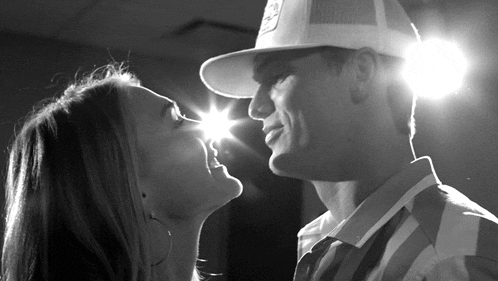 a man and a woman are looking into each others eyes
