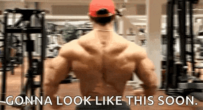 a muscular man in a red hat is standing in a gym and says `` gonna look like this soon '' .