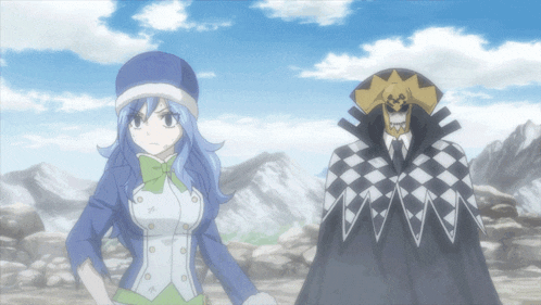 a woman in a blue hat stands next to a man in a checkered cape