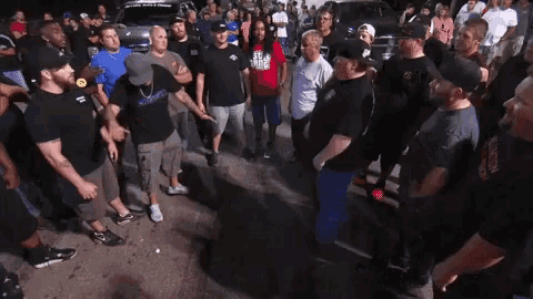 a group of people are standing in a circle with one man wearing a shirt that says ' a few dollars '