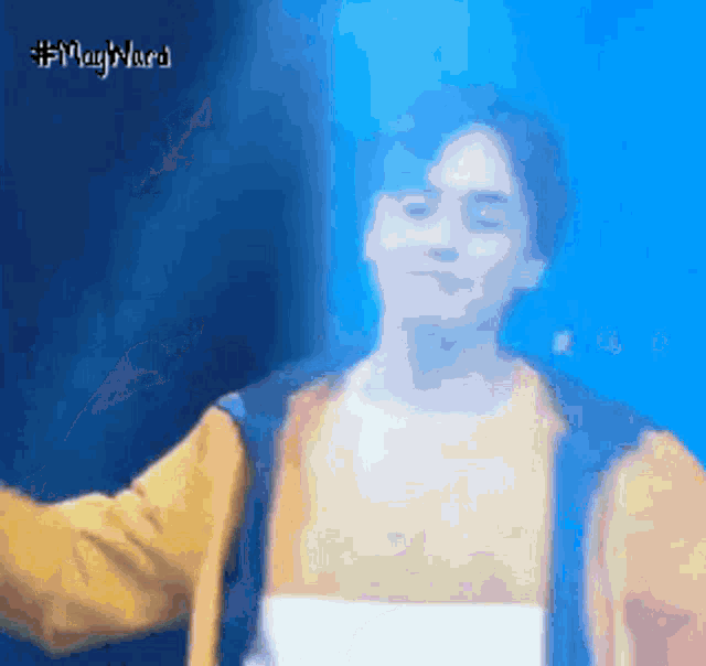 a blurry picture of a man in a yellow jacket with a blue background and the hashtag #maryyura on it