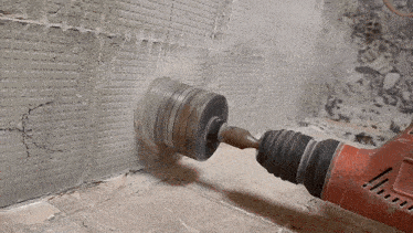 a milwaukee brand drill is being used to drill into a wall