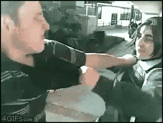 a pixelated image of a man and a woman with 4gifs.com in the corner
