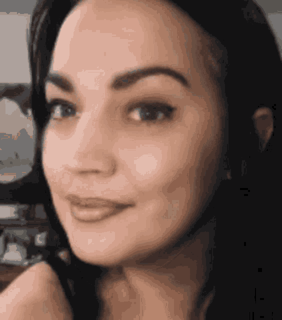 a close up of a woman 's face with a smile .