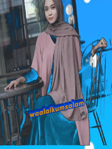 a woman in a hijab sits at a table with a sign that says waalaikumsalam