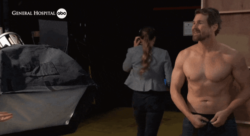 a shirtless man is standing in front of a general hospital abc logo