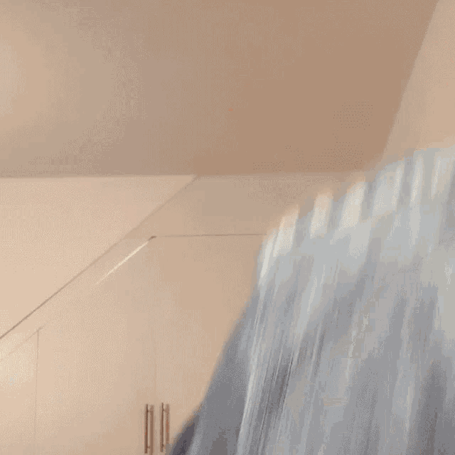 a blurry picture of a person standing in front of a staircase