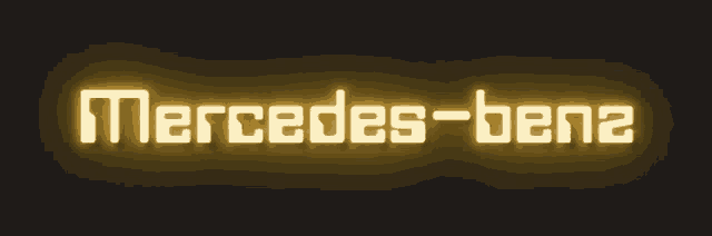 a neon sign that says mercedes-benz on a dark background