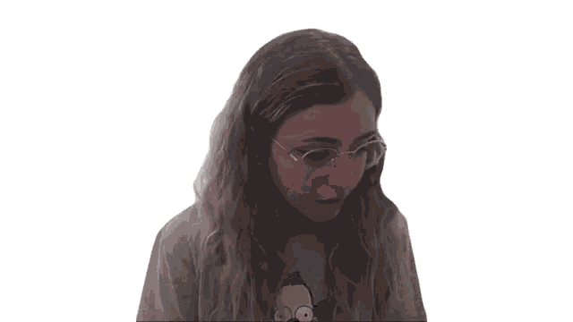 a young woman wearing glasses and a simpson t-shirt is talking on a video call .