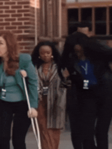 a woman with crutches and a name tag that has the letter j on it