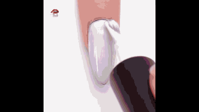 a person is applying nail polish to their nails with a brush .