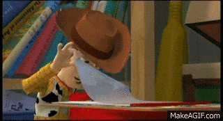 woody from toy story is holding a piece of paper .