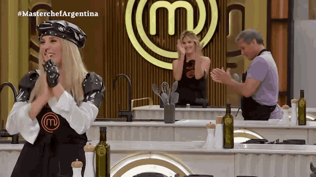 a woman stands in front of a masterchef argentina logo