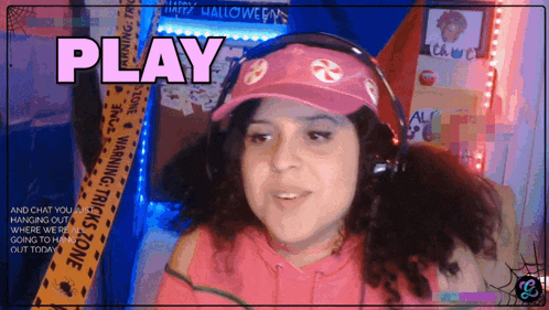 a woman wearing headphones and a pink hat with the word play on it