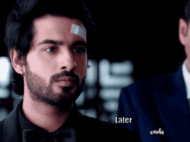 a man with a bandage on his forehead has the word later on the bottom right