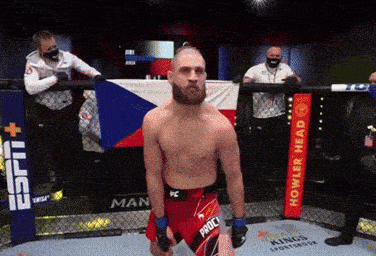 a man standing in a ring with a sign that says howler head