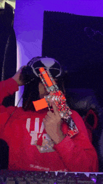a person wearing a red sweatshirt that says ua on it