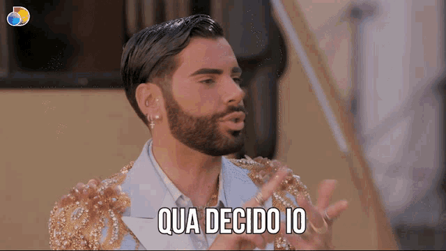 a man with a beard says qua decidio io with his hands outstretched