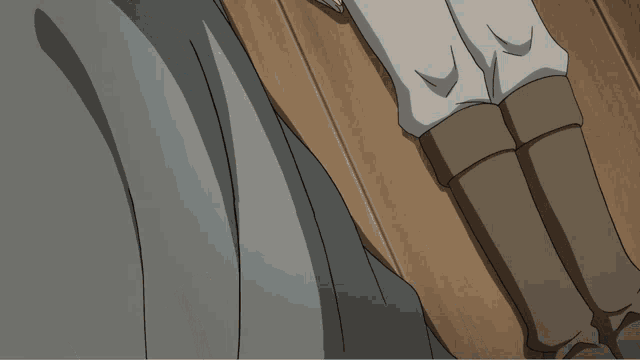 a person laying on a wooden floor with their hands on their knees