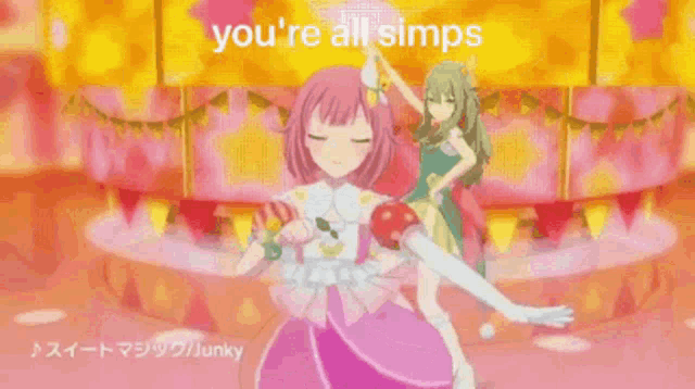 two anime girls are dancing on a stage and one of them is giving the middle finger .